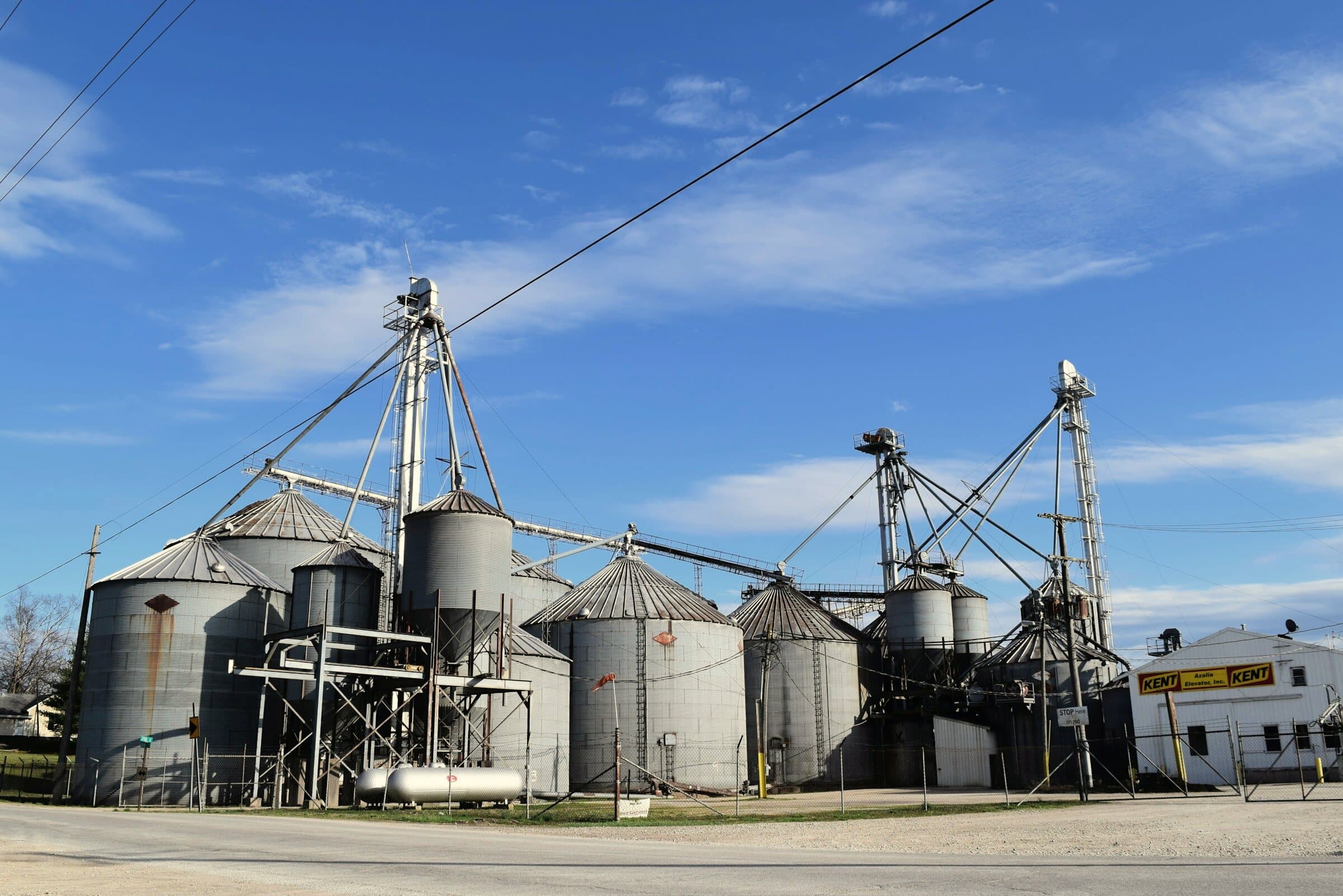 Grain elevators beside a town road in Azalia, Indiana.