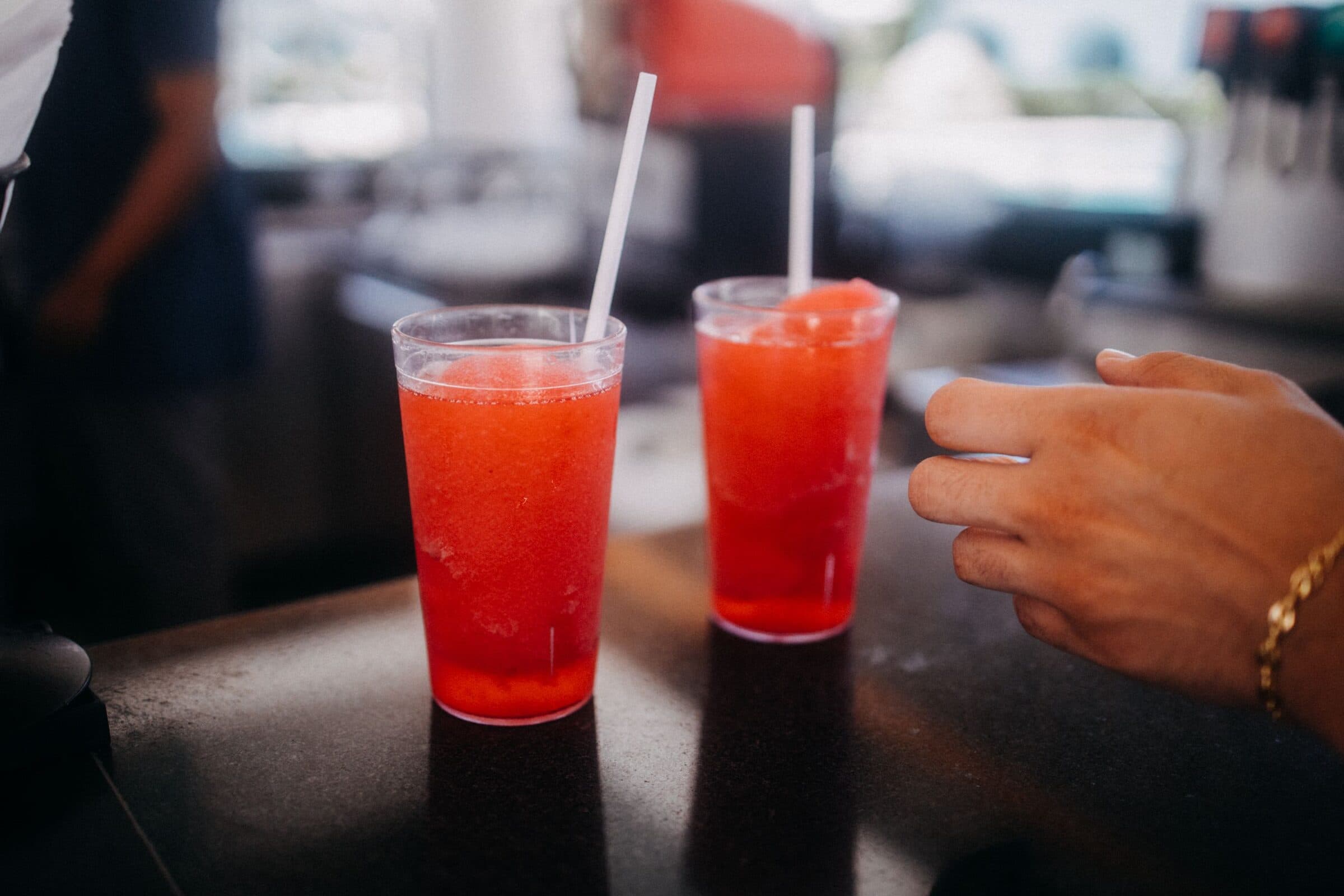Two red slushies on a counter.